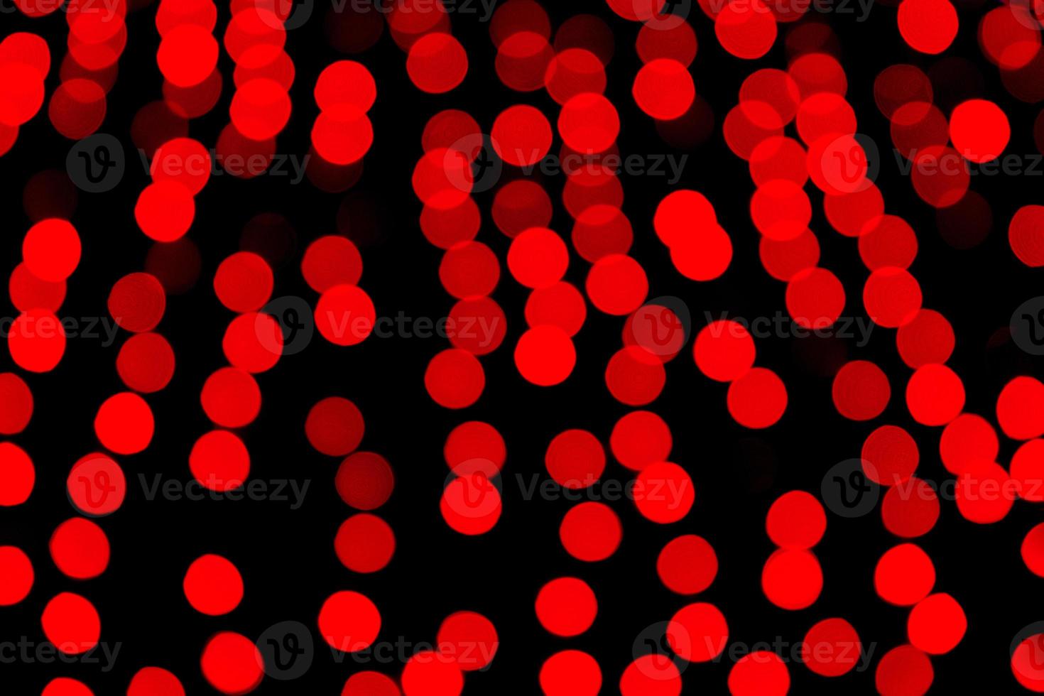 Unfocused abstract red bokeh on black background. defocused and blurred many round light photo