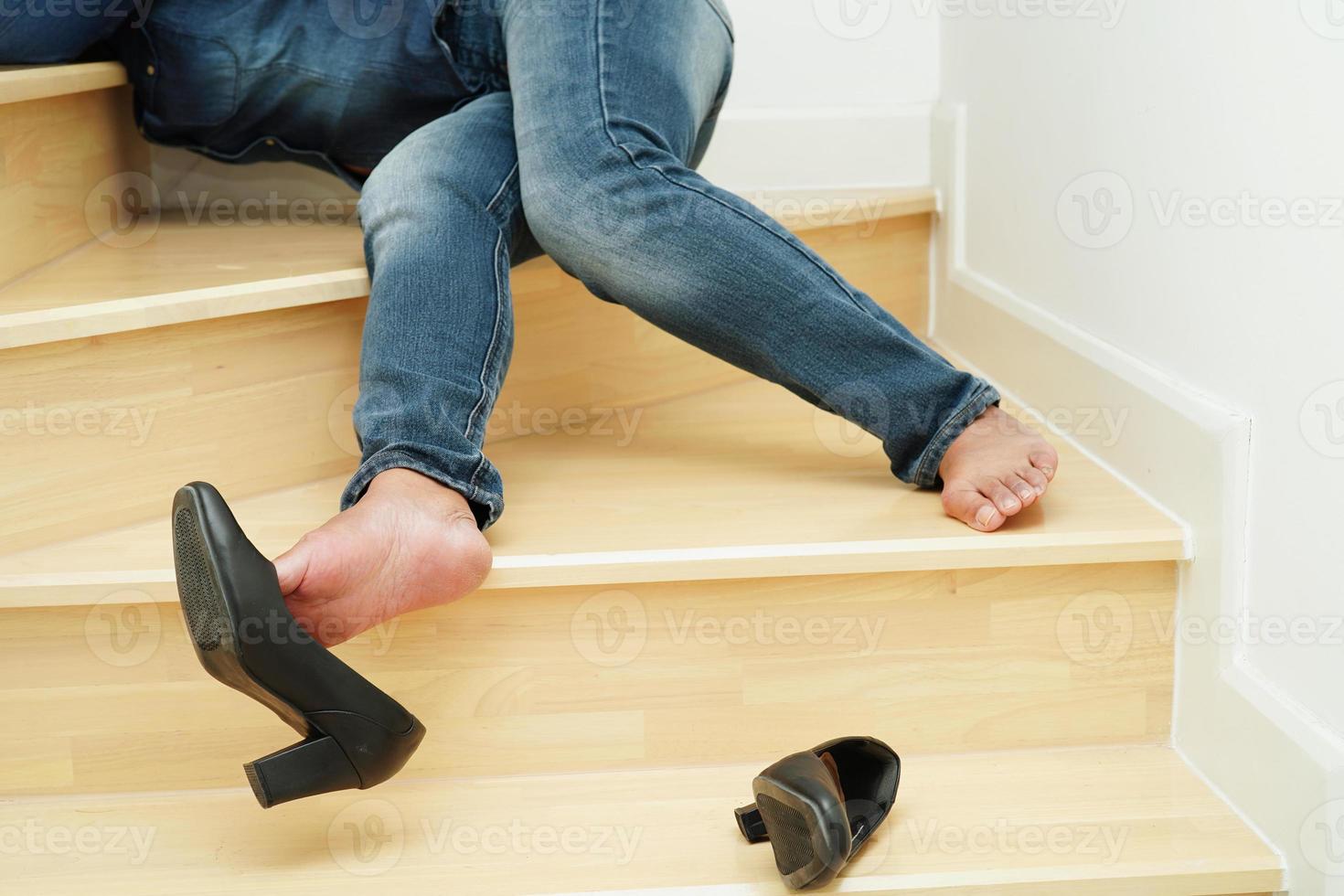Asian business woman pain ankle, foot with leg cramp and fall down the stairs because slippery surfaces in office. photo