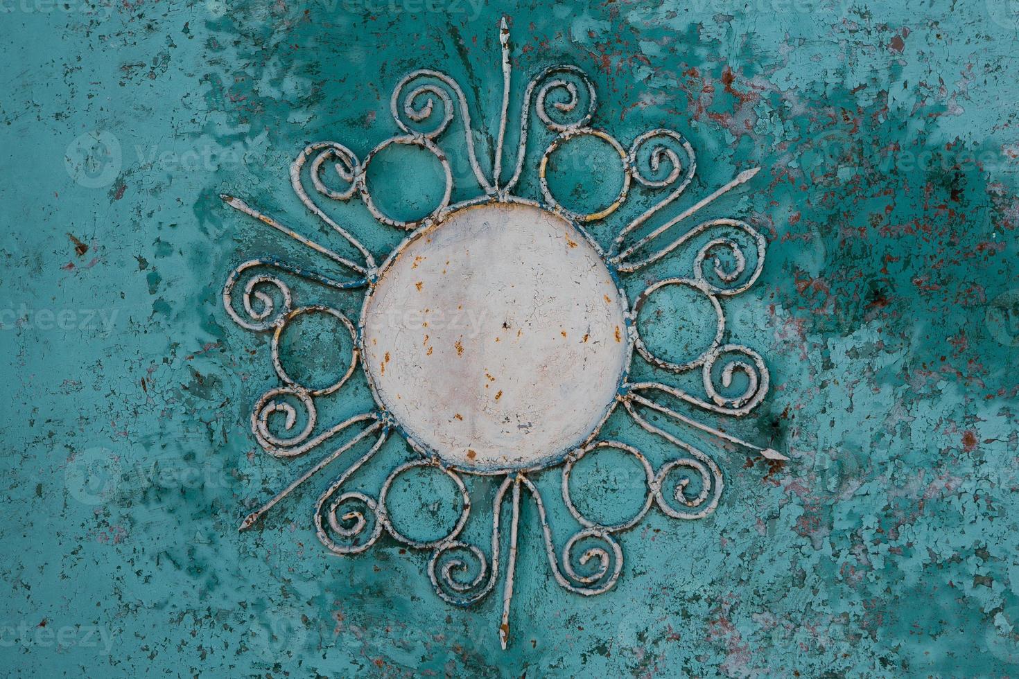 Iron background with beautiful ornament with a sun. photo