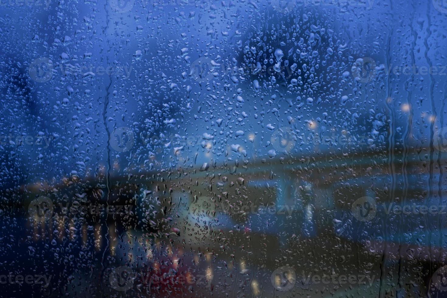 Rainy window, raindrops on the glass against the background of the highway and the bridge. Safe way home. photo