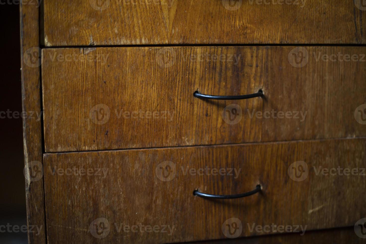 Drawer in table. Wooden boxes in room. Handles on board. photo
