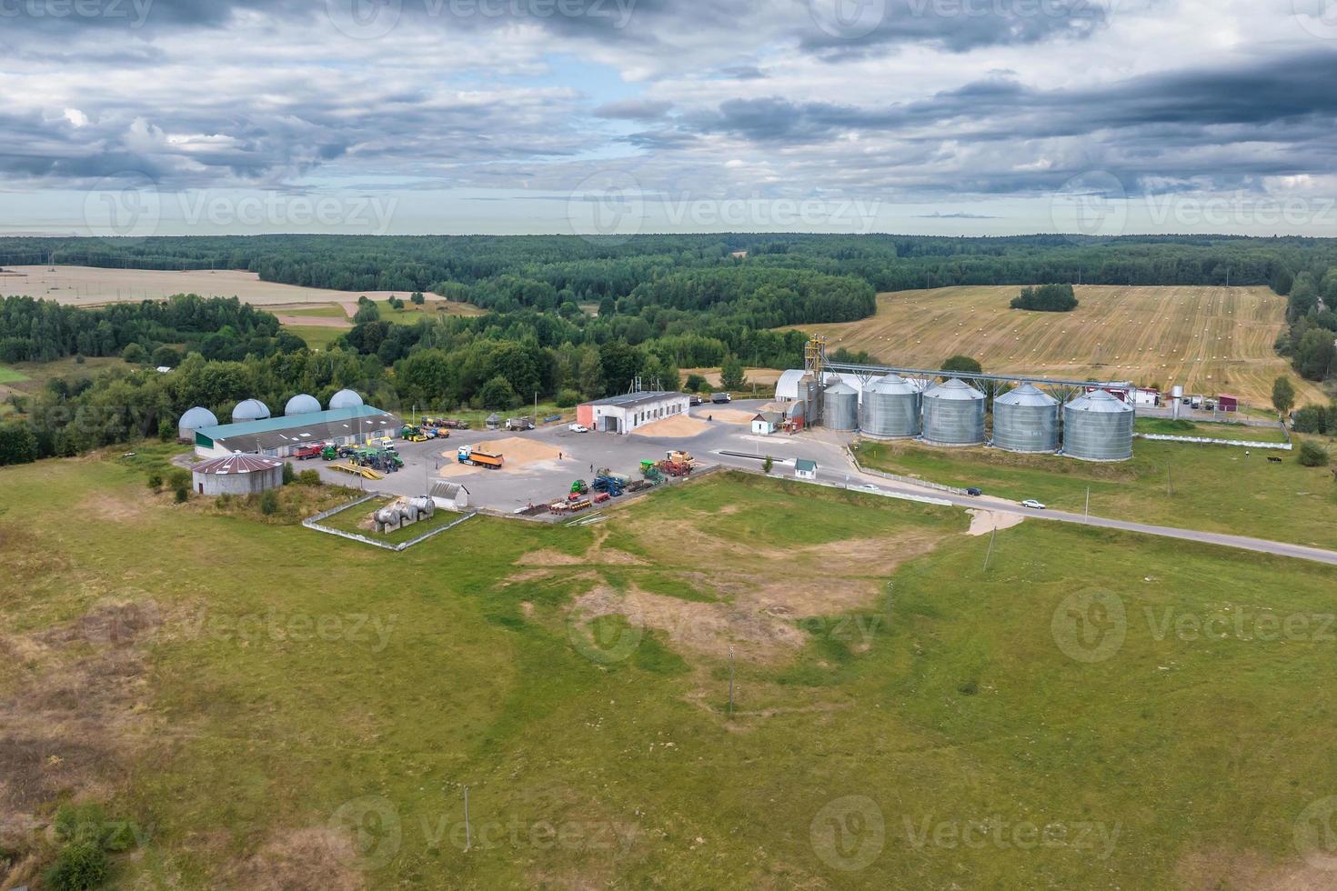 aerial view on rows of agro silos granary elevator with seeds cleaning line on agro-processing manufacturing plant for processing drying cleaning and storage of agricultural products photo
