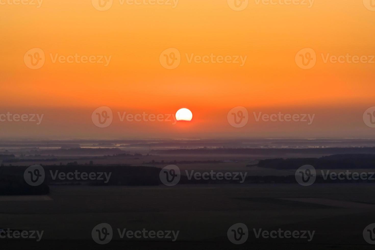 red sun of sunrise or sunset in the early morning or evening photo