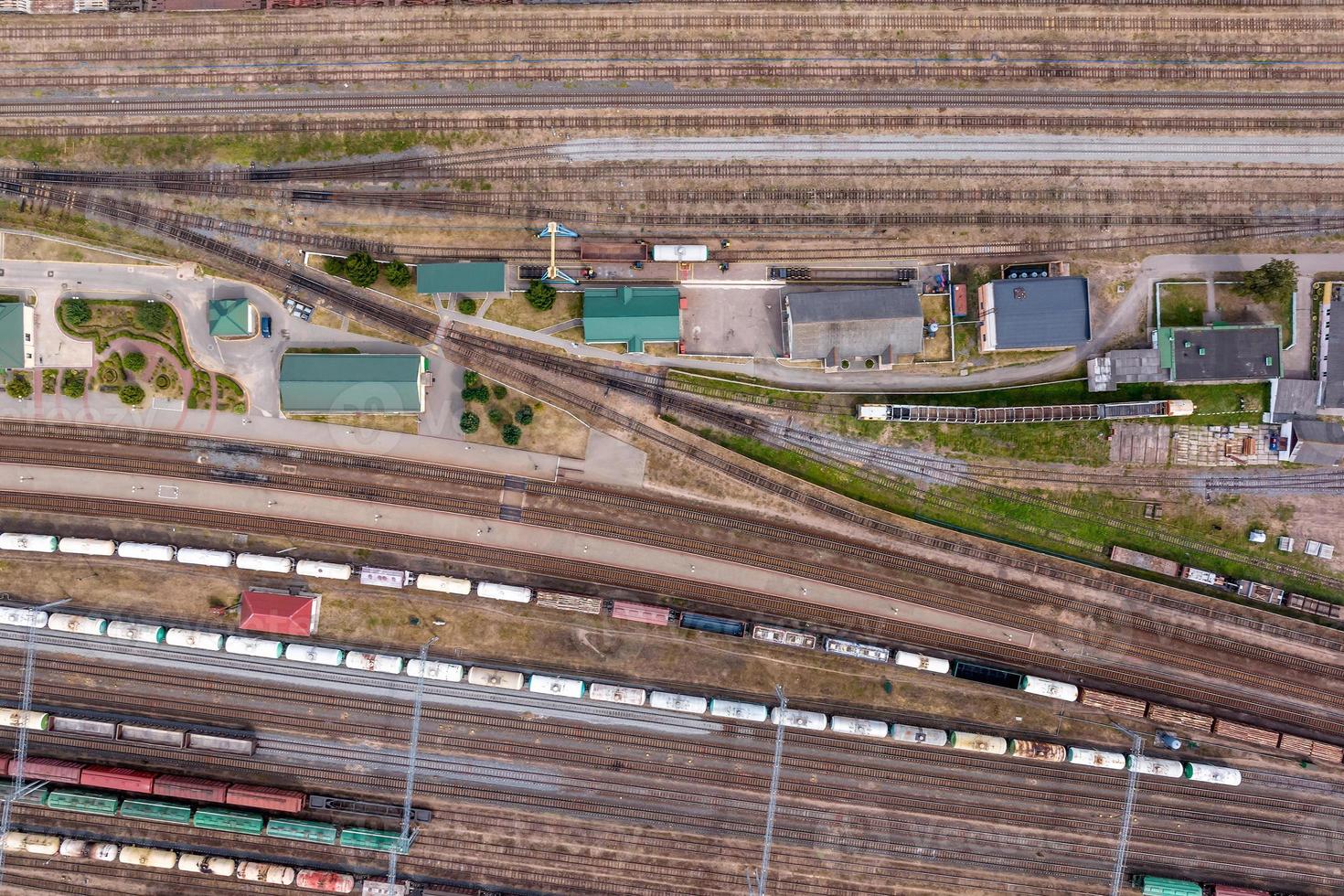 aerial view over long railway freight trains with lots of wagons stand on parking photo