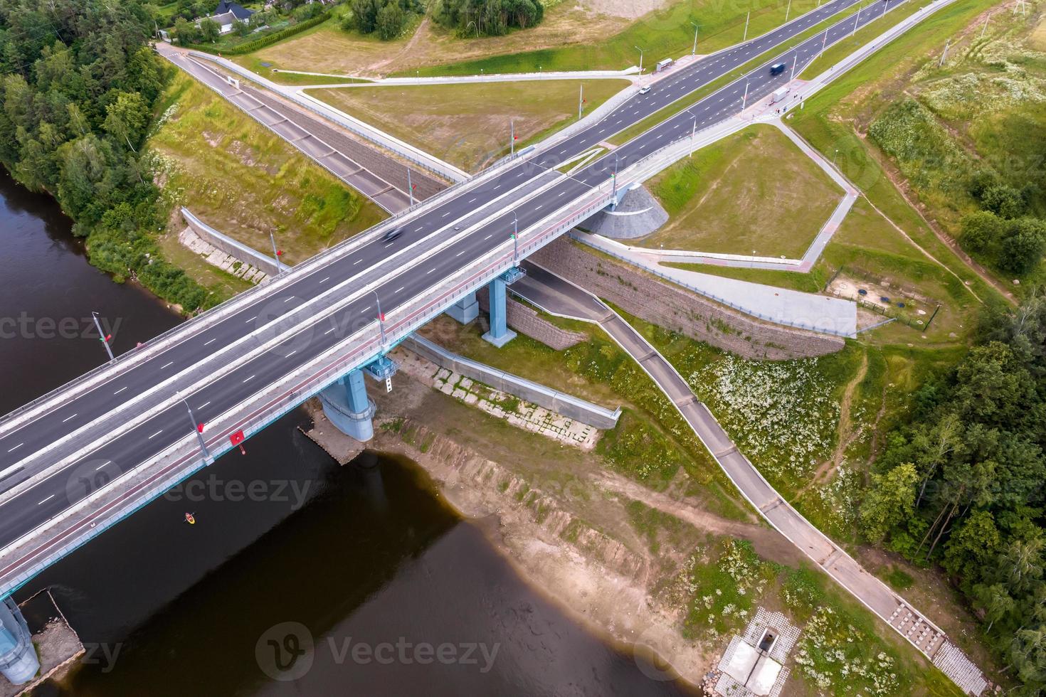 aerial view on huge bridge with a wide multi-lane road across a wide river photo