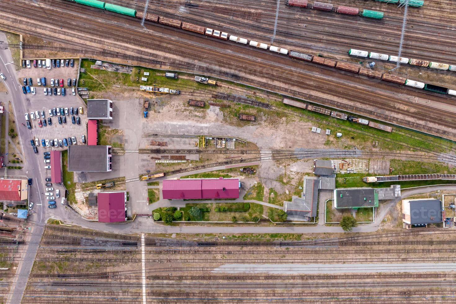 aerial view over long railway freight trains with lots of wagons stand on parking photo