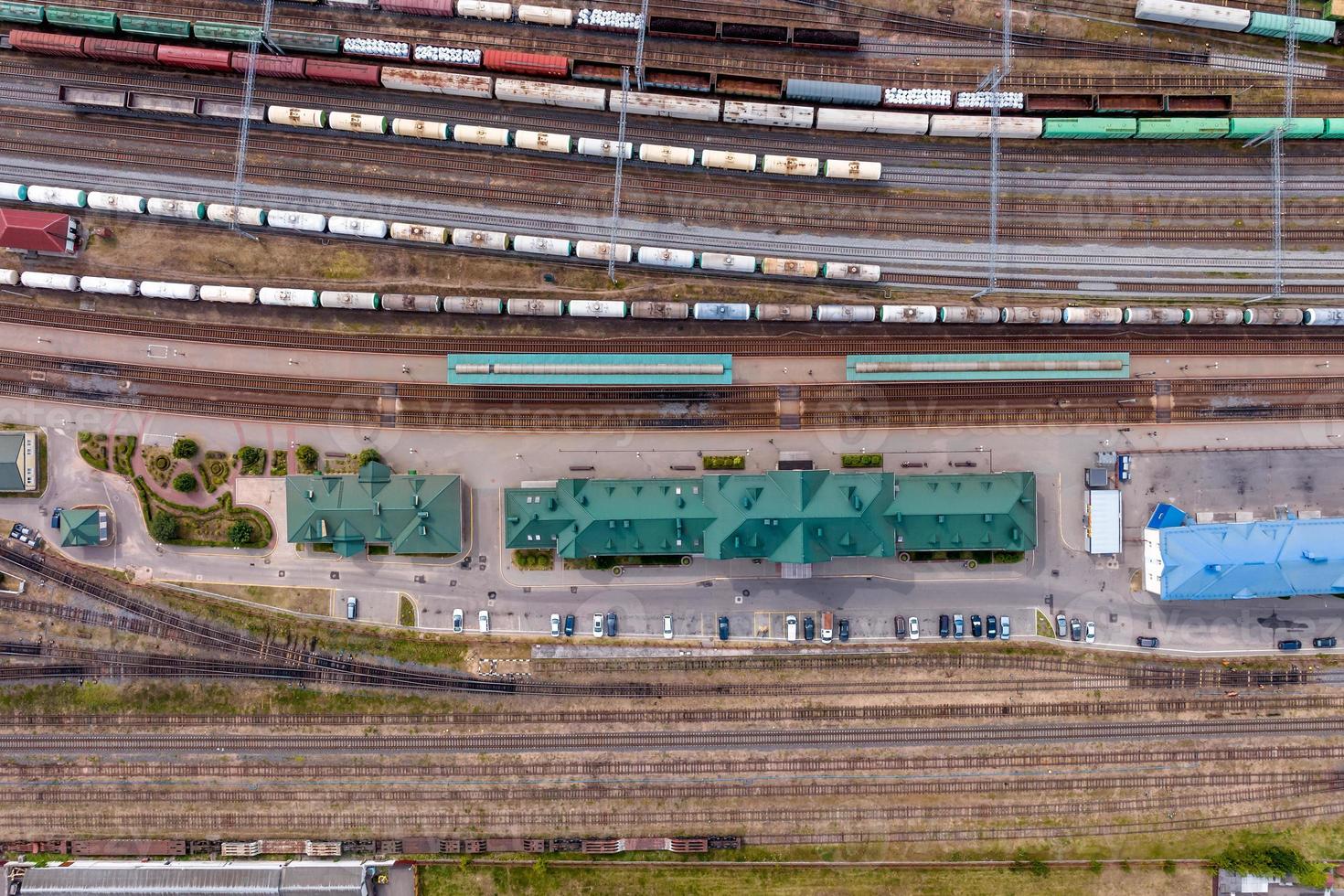 aerial view over long railway freight trains with lots of wagons stand on parking photo