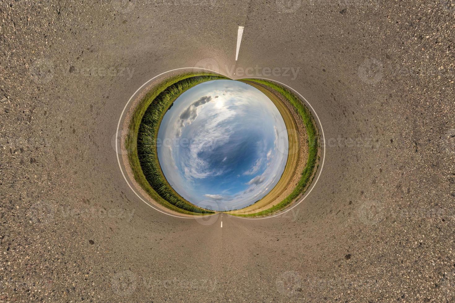 blue sphere little planet inside gravel road or field background. curvature of space photo