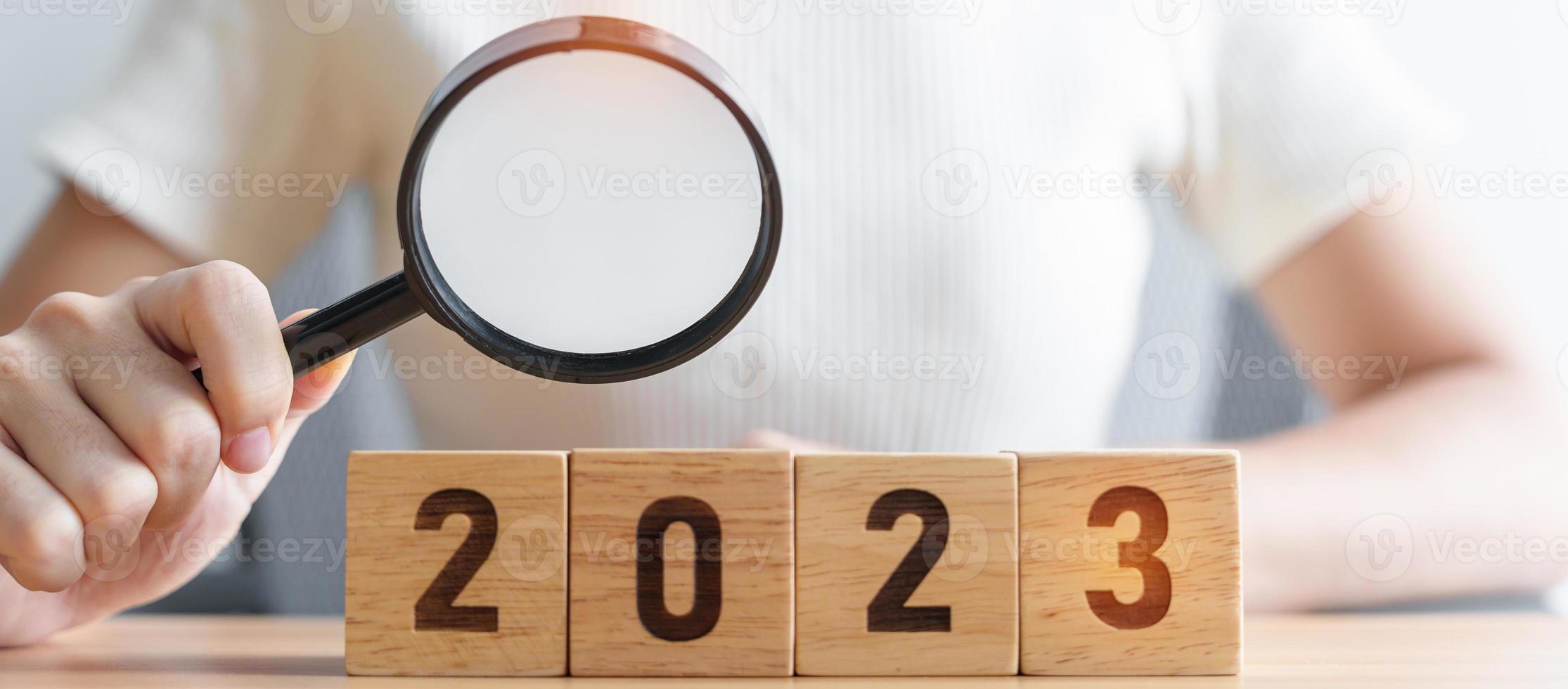 2023 block with magnifying glass. SEO, Search Engine Optimization, hiring , Advertising, Idea, Strategy, marketing, Keyword, Content and New Year start concepts photo