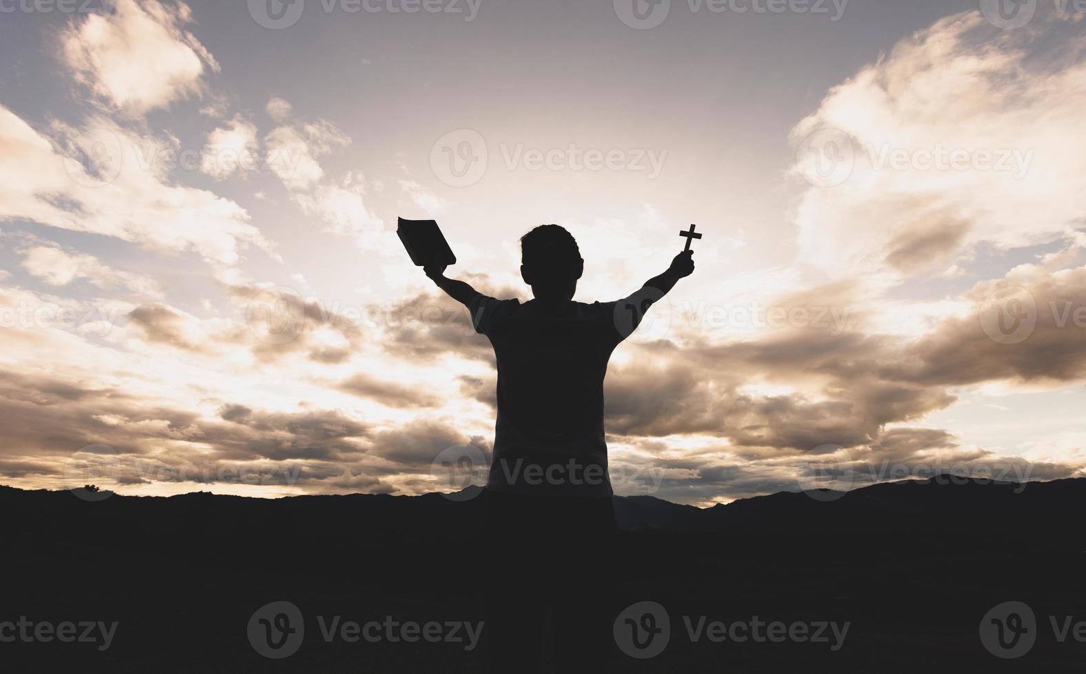 Silhouette of a woman with hands raised in the sunset concept for religion, worship, prayer and praise, Religious concepts photo