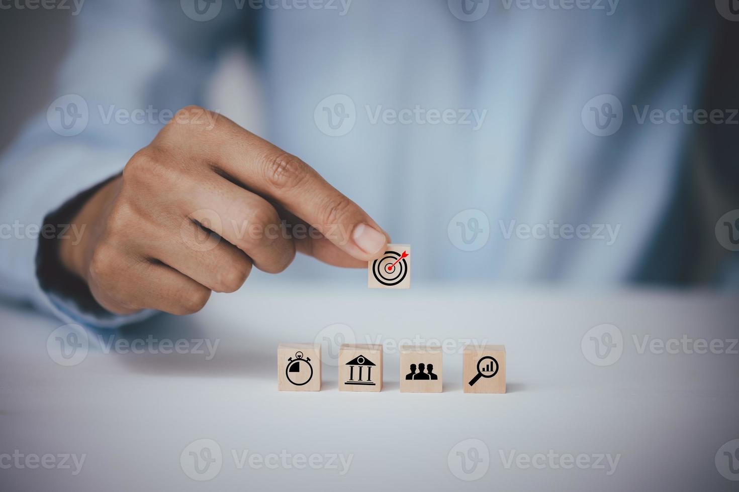 Hand holding a wooden block with  icon Action plantarget icon,  icon Action plan, Goal and target, success and business target concept, project management, company strategy development. photo