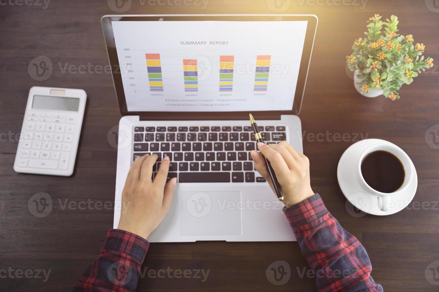 Young Businessman Analyzing Graph On Computer At Workplace photo