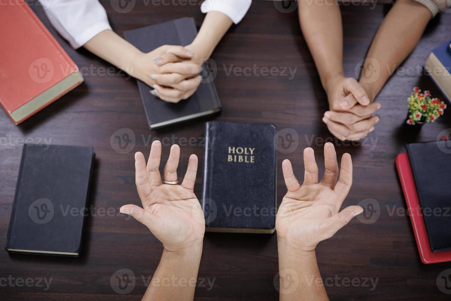 Asian Christian groups sitting within the Church Catholic prayed for blessings from God. A pale sun shone in a place of worship.Religious concepts. photo