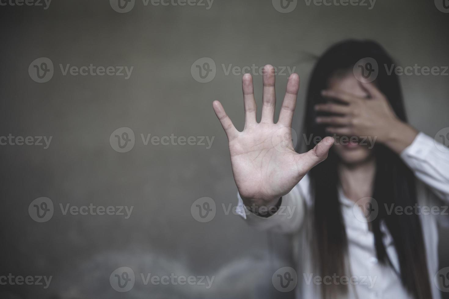 woman using hand palm to stop. stop violence against women campaign concept with copy space. photo