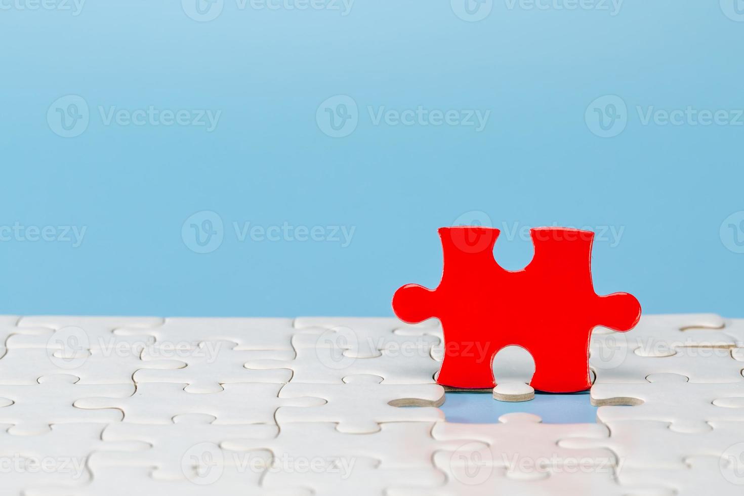 Blue background made from red and white  puzzle pieces and place for your content. photo