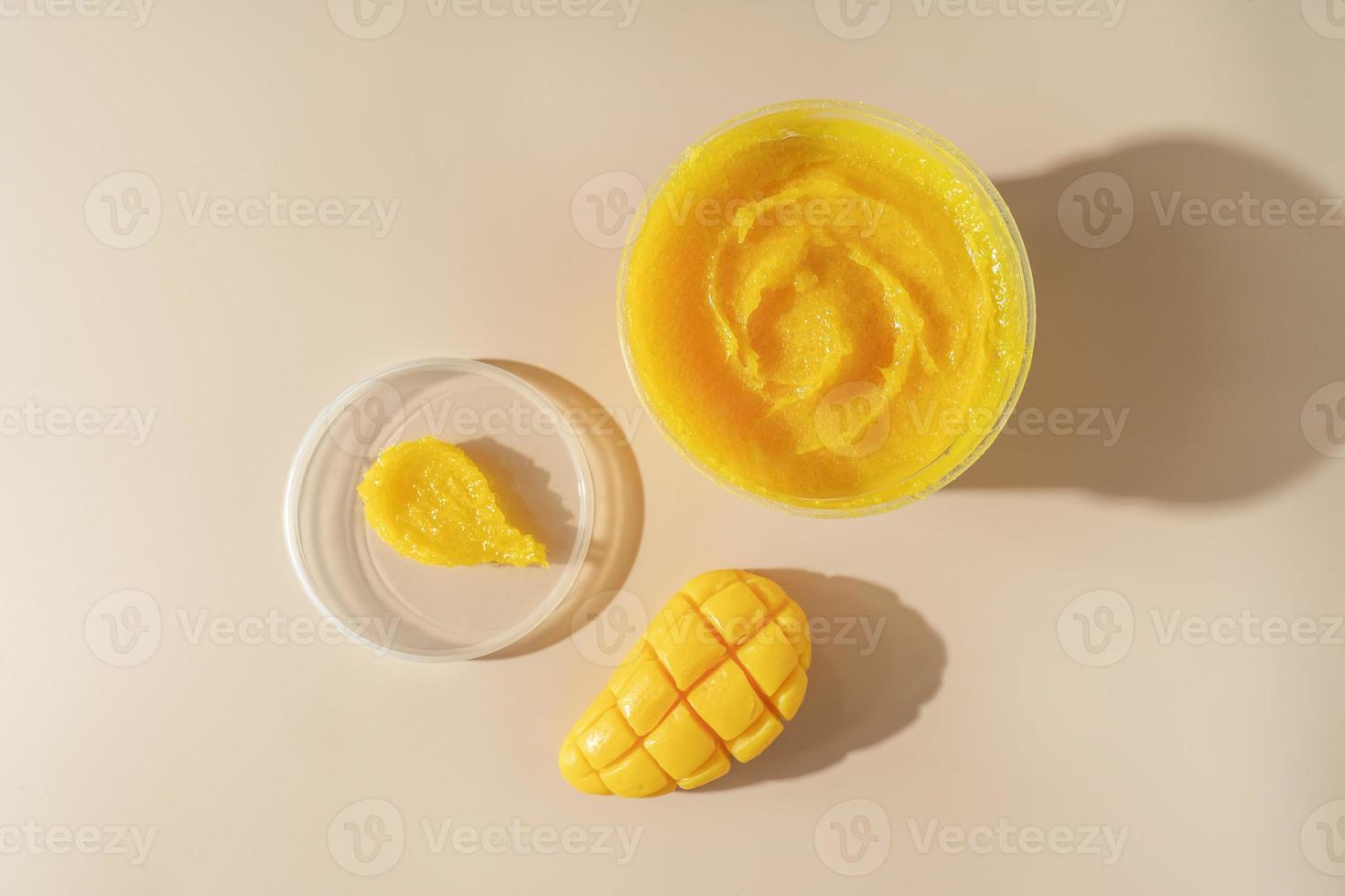 A body care natural mango soap and a yellow cosmetic smudge for spa procedures standing on a beige background photo