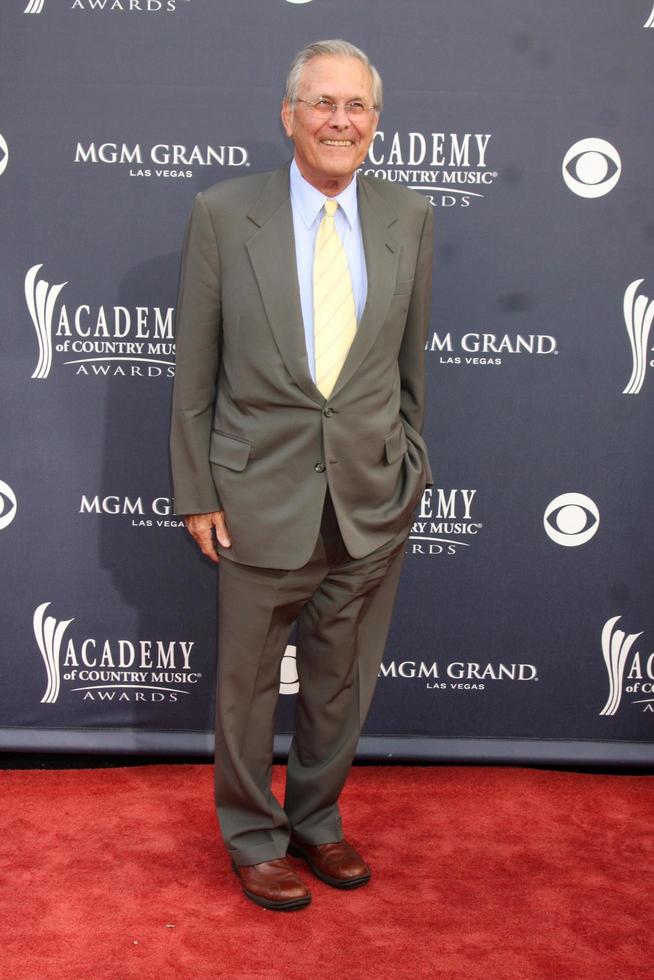LAS VEGAS - APR 3 - Donald Rumsfeld arriving at the Academy of Country Music Awards 2011 at MGM Grand Garden Arena on April 3, 2010 in Las Vegas, NV photo