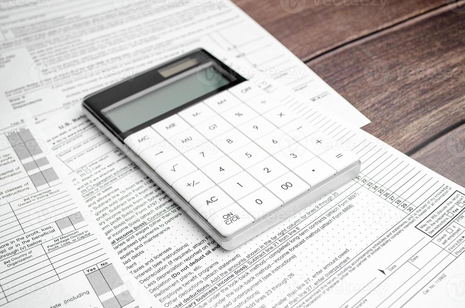 Business concept - financial report and pen, calculator and charts photo