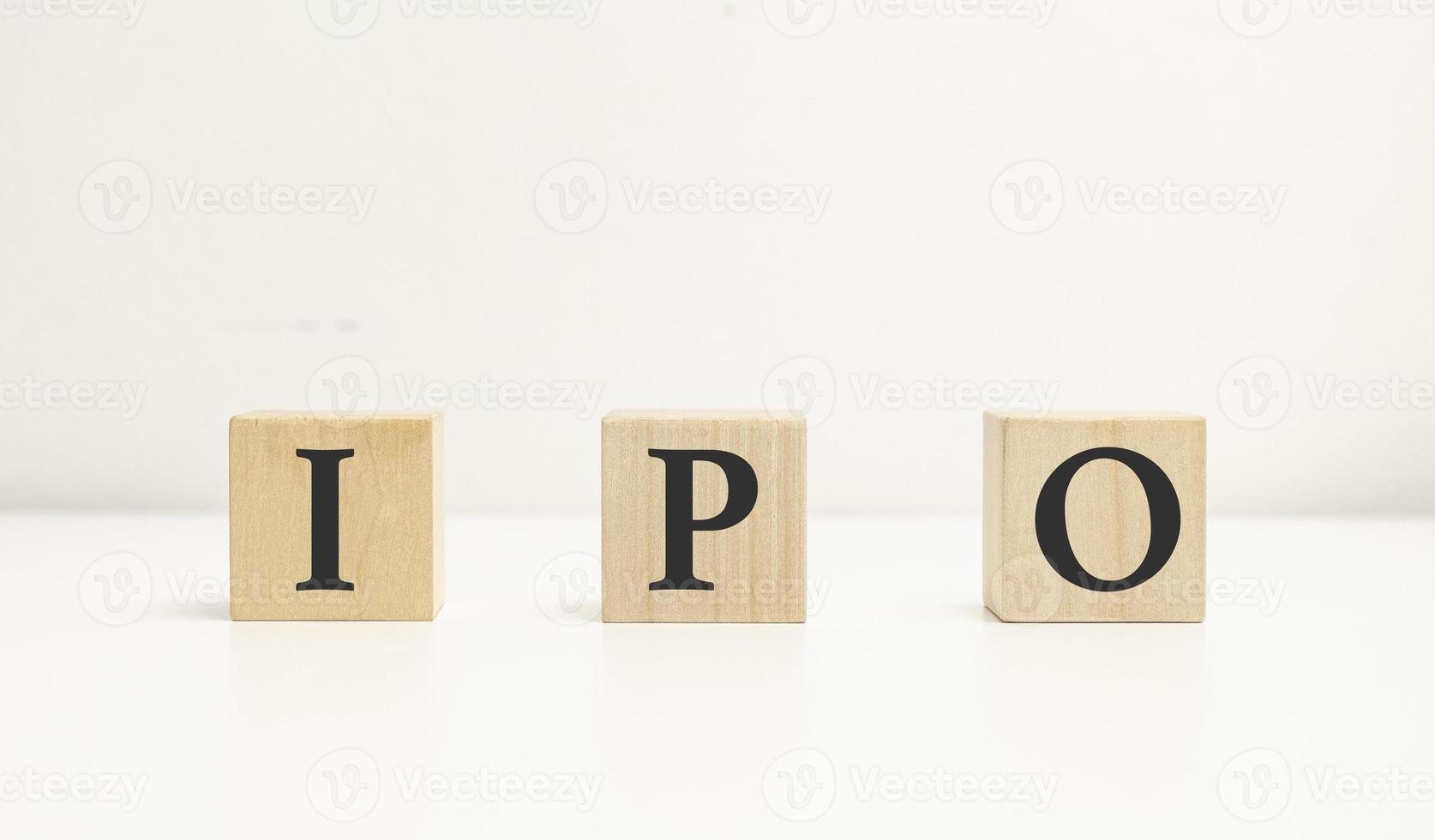 IPO word of wooden cube or block concept on wooden background. photo