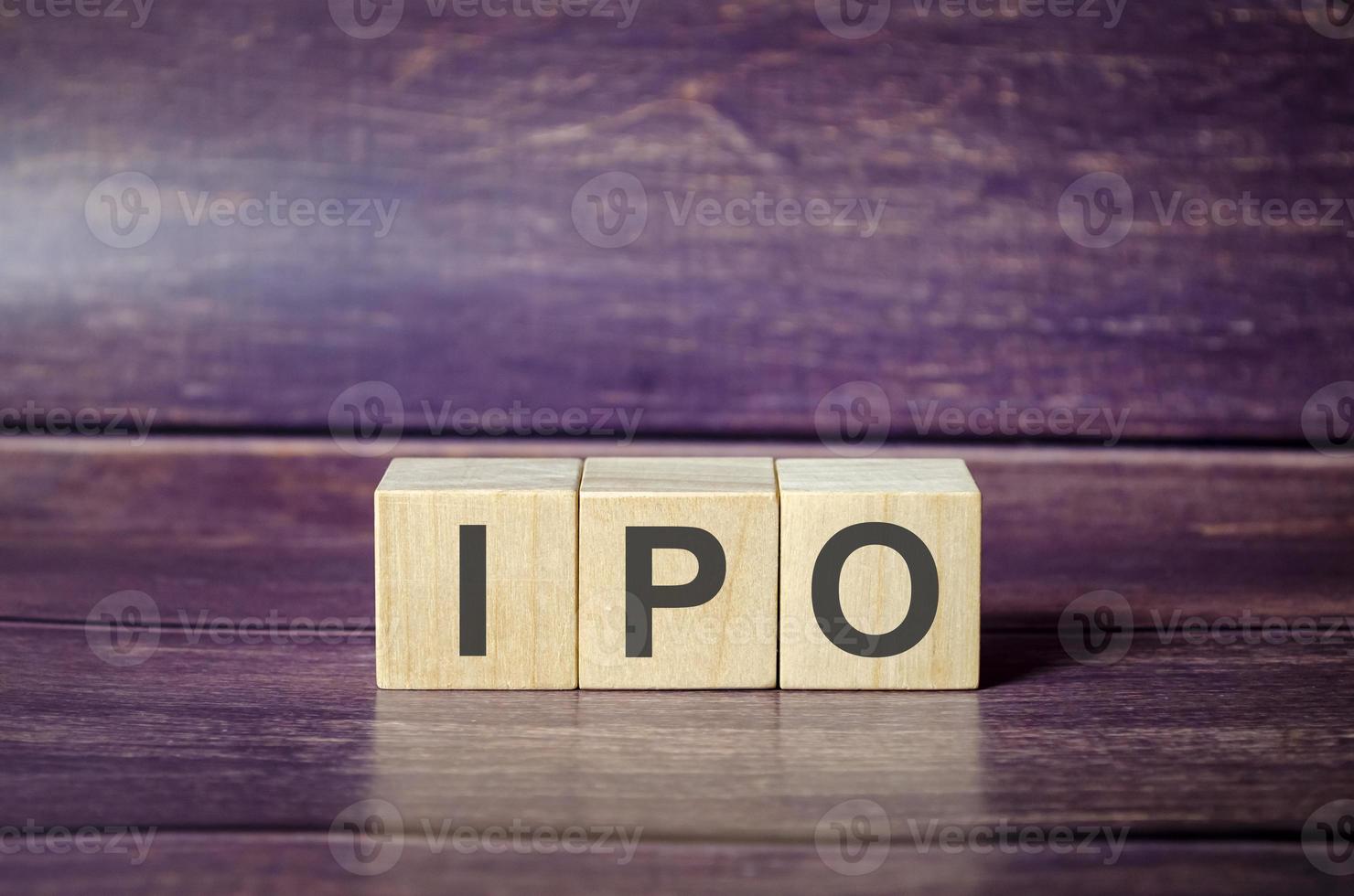 IPO word of wooden cube or block concept on wooden background. photo