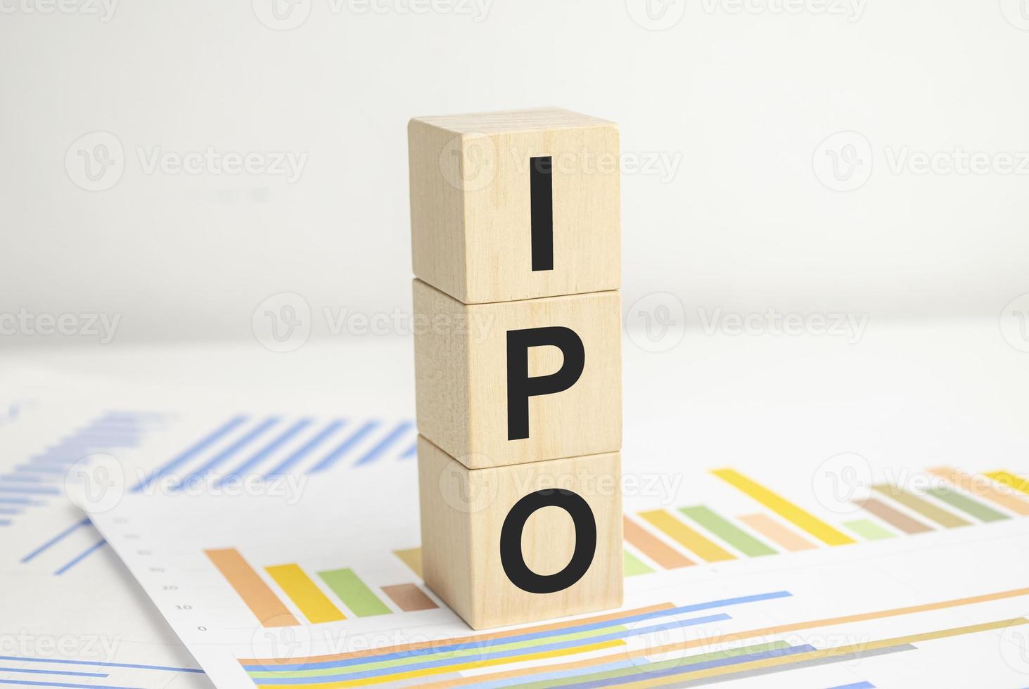 IPO word of wooden cube and charts on white background photo