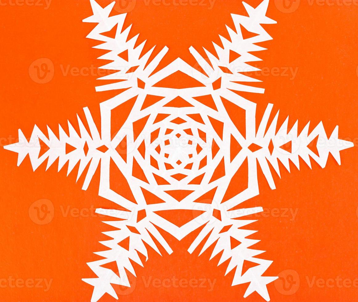 white snowflake on orange paper photo