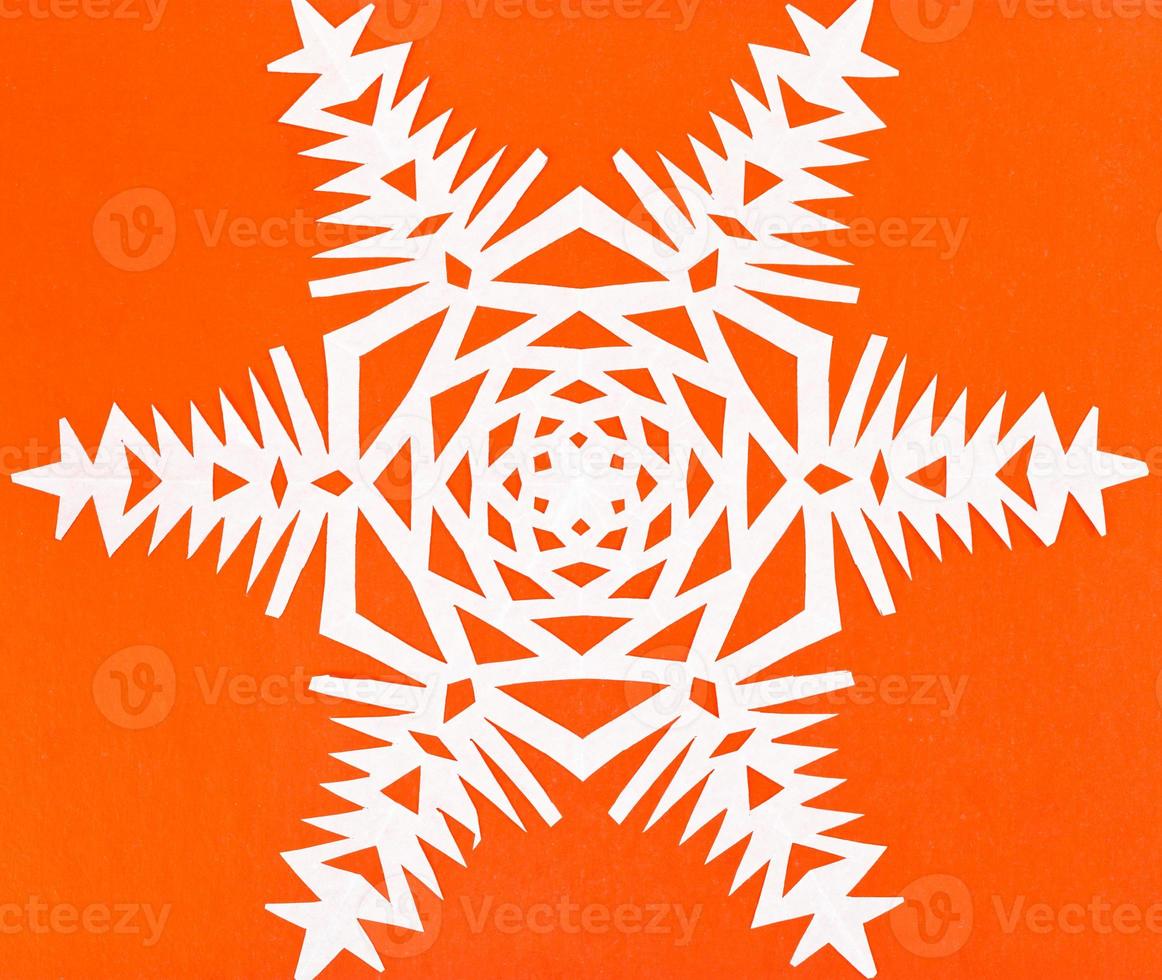 white snowflake on orange paper photo