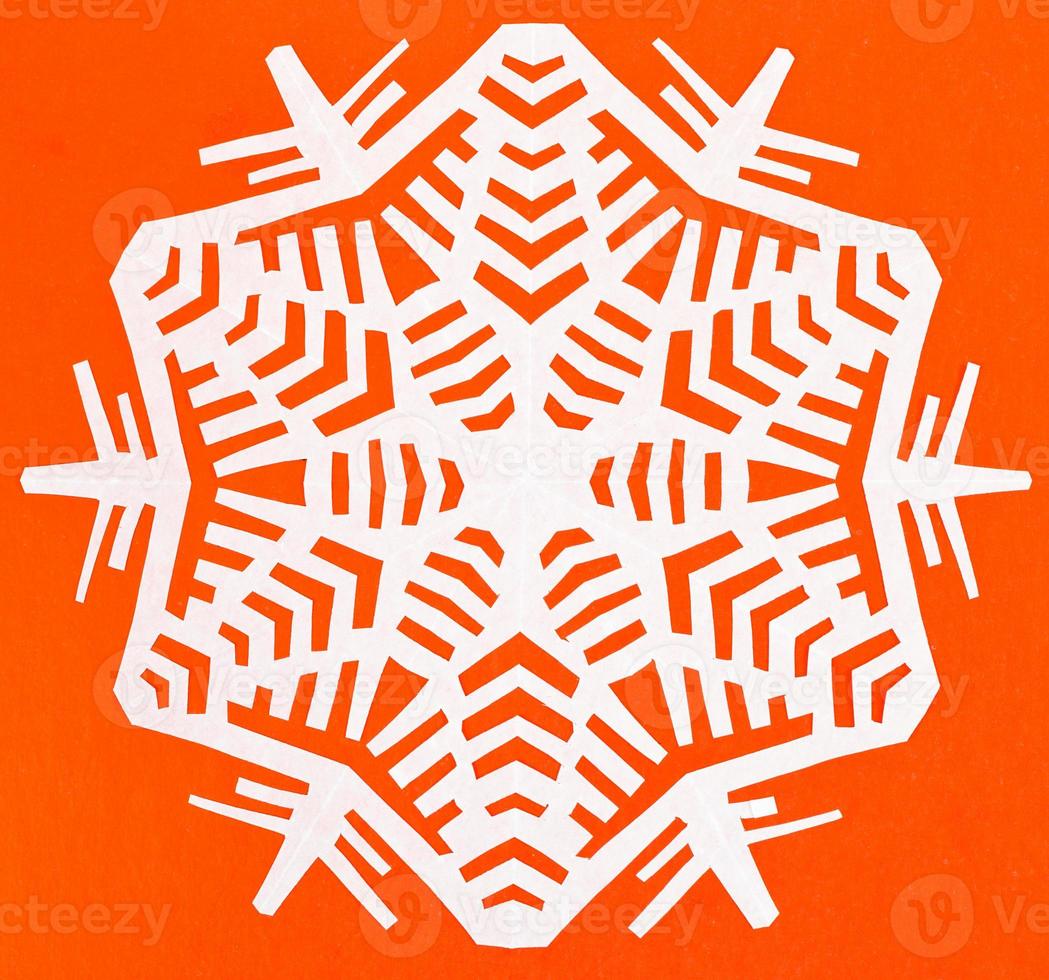 white snowflake on orange paper photo