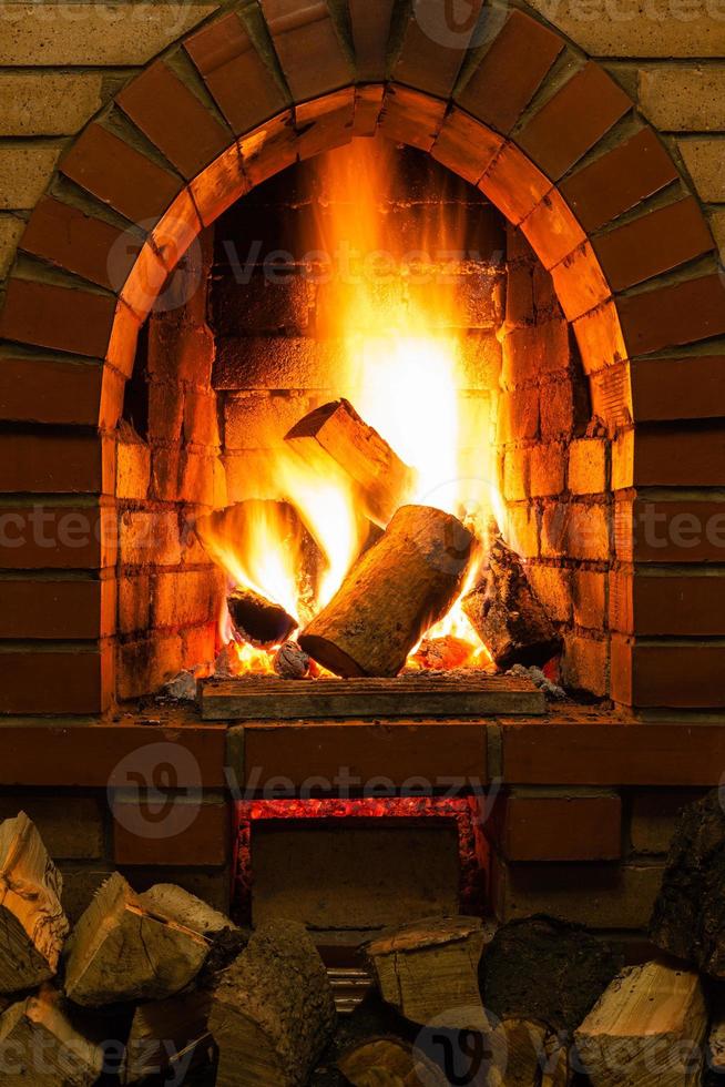 firewood and fire in fireplace photo