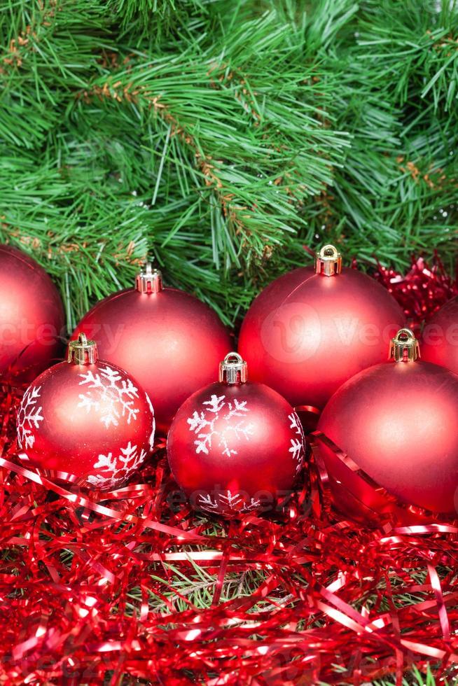 many red Christmas balls, tinsel and Xmas tree photo