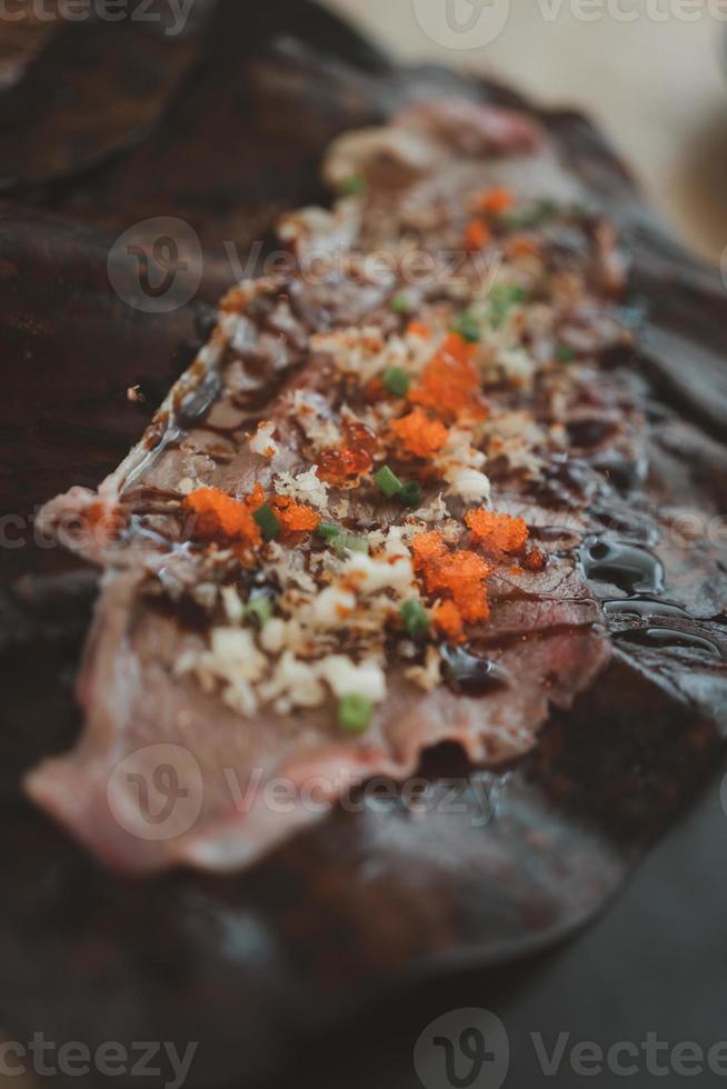 Close up of Wagyu Hoba Yaki beef grilled on dried leaf. 13226102 Stock
