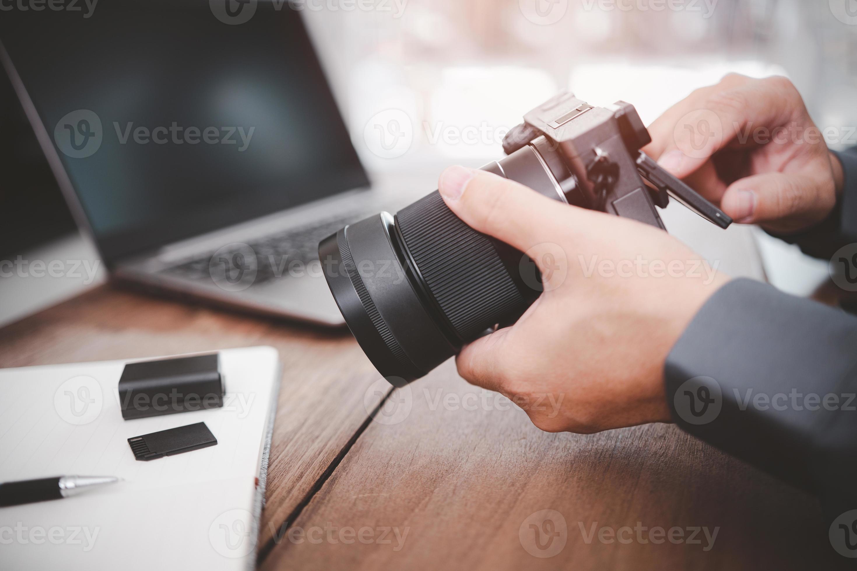 Close up camera in hand a business man and check photo in camera