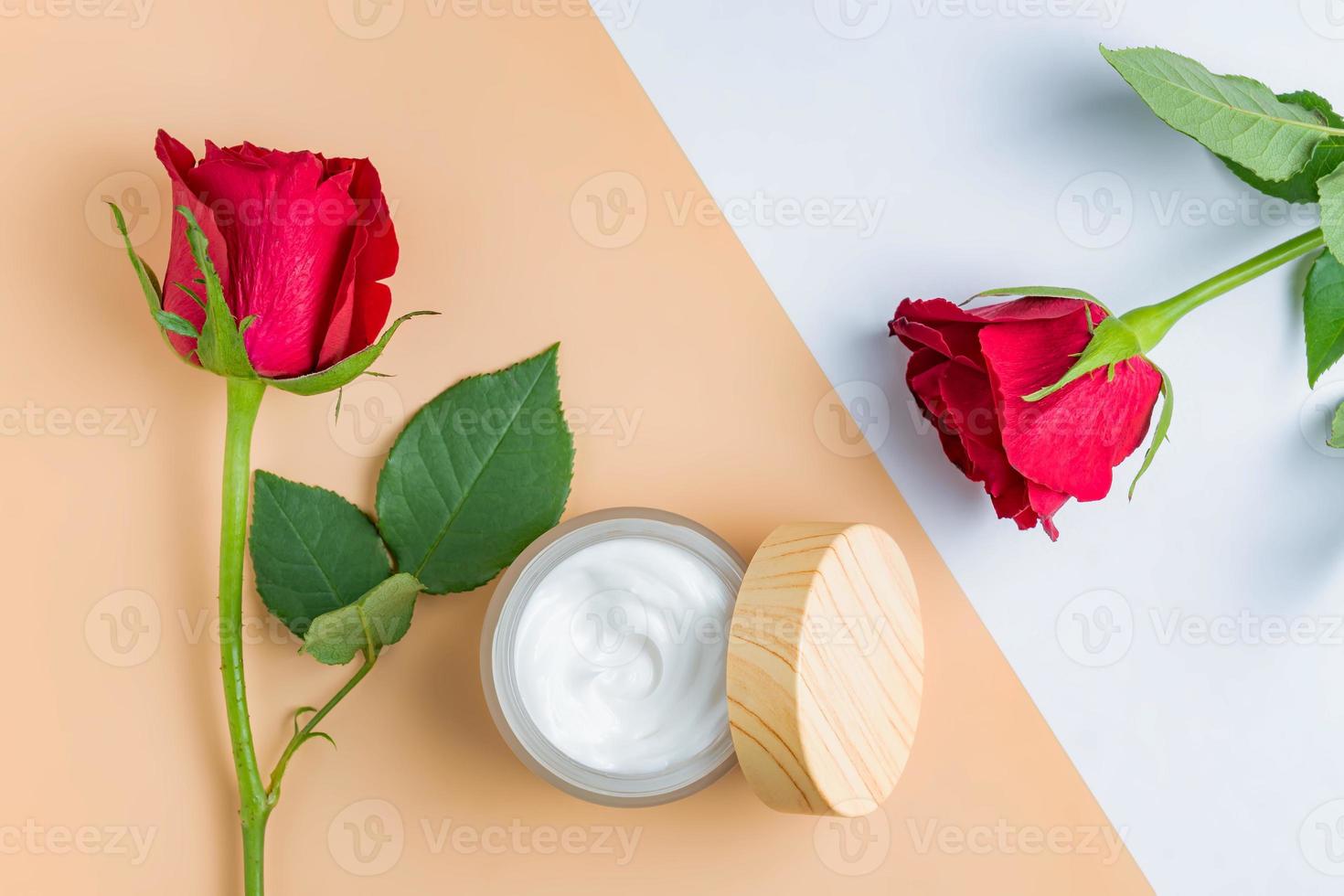 Cosmetic cream with essential rose oil and roses on a beige background. A natural product for detoxifying, moisturizing, toning and regenerating the skin. Unbranded product mockup. photo