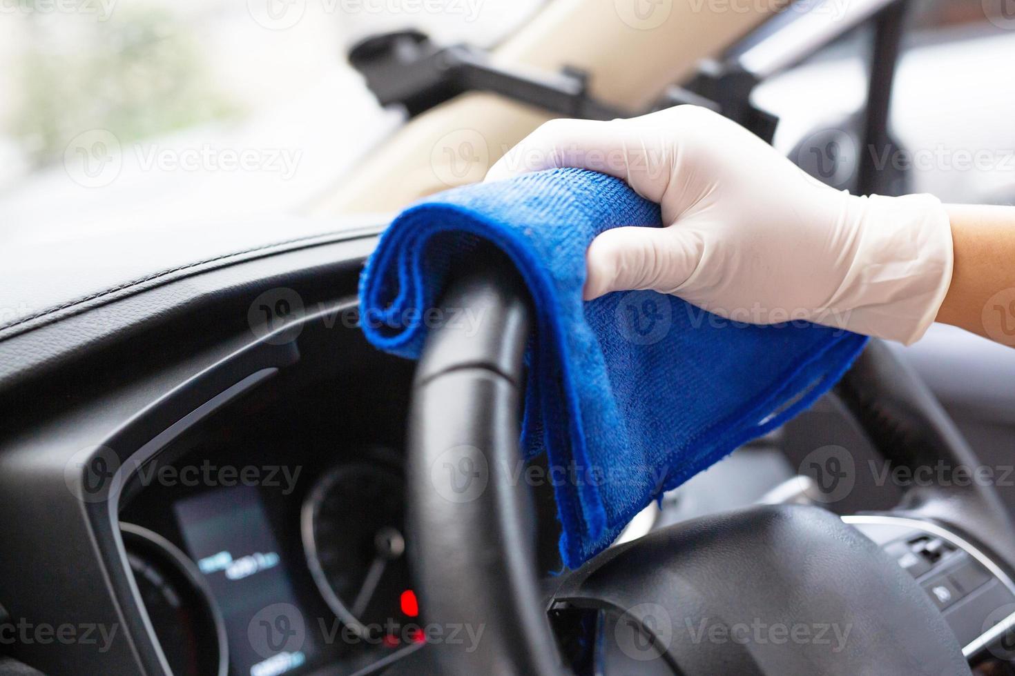 Car care workers wash, spray and clean the car. photo