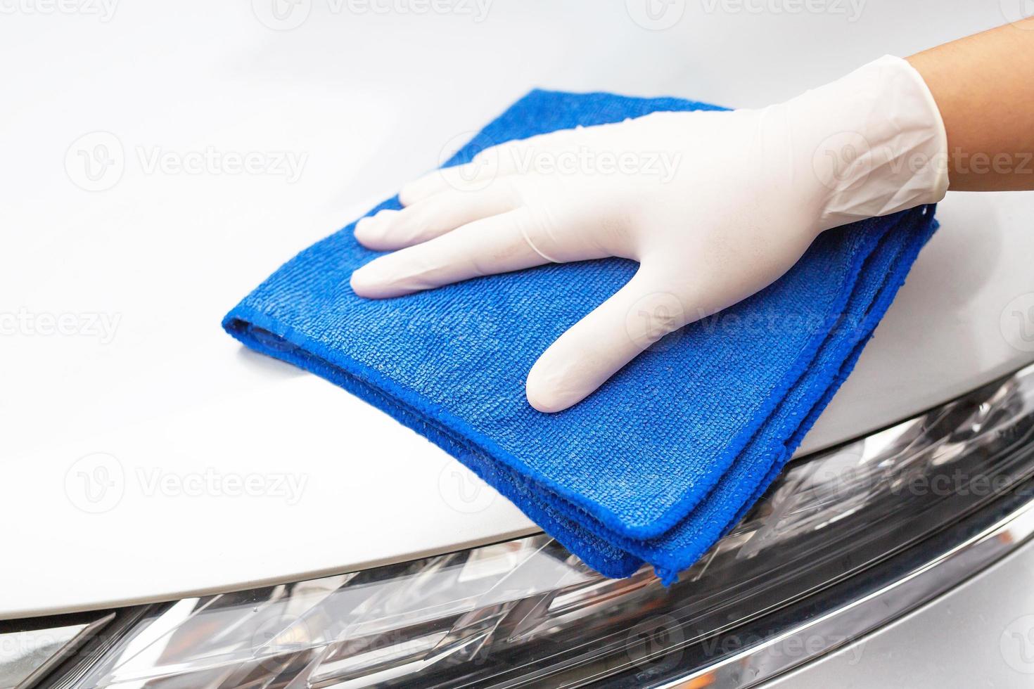 Car care workers wash, spray and clean the car. photo