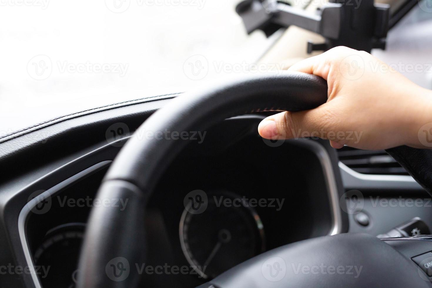 A woman caught the steering wheel of a car while driving to work. photo