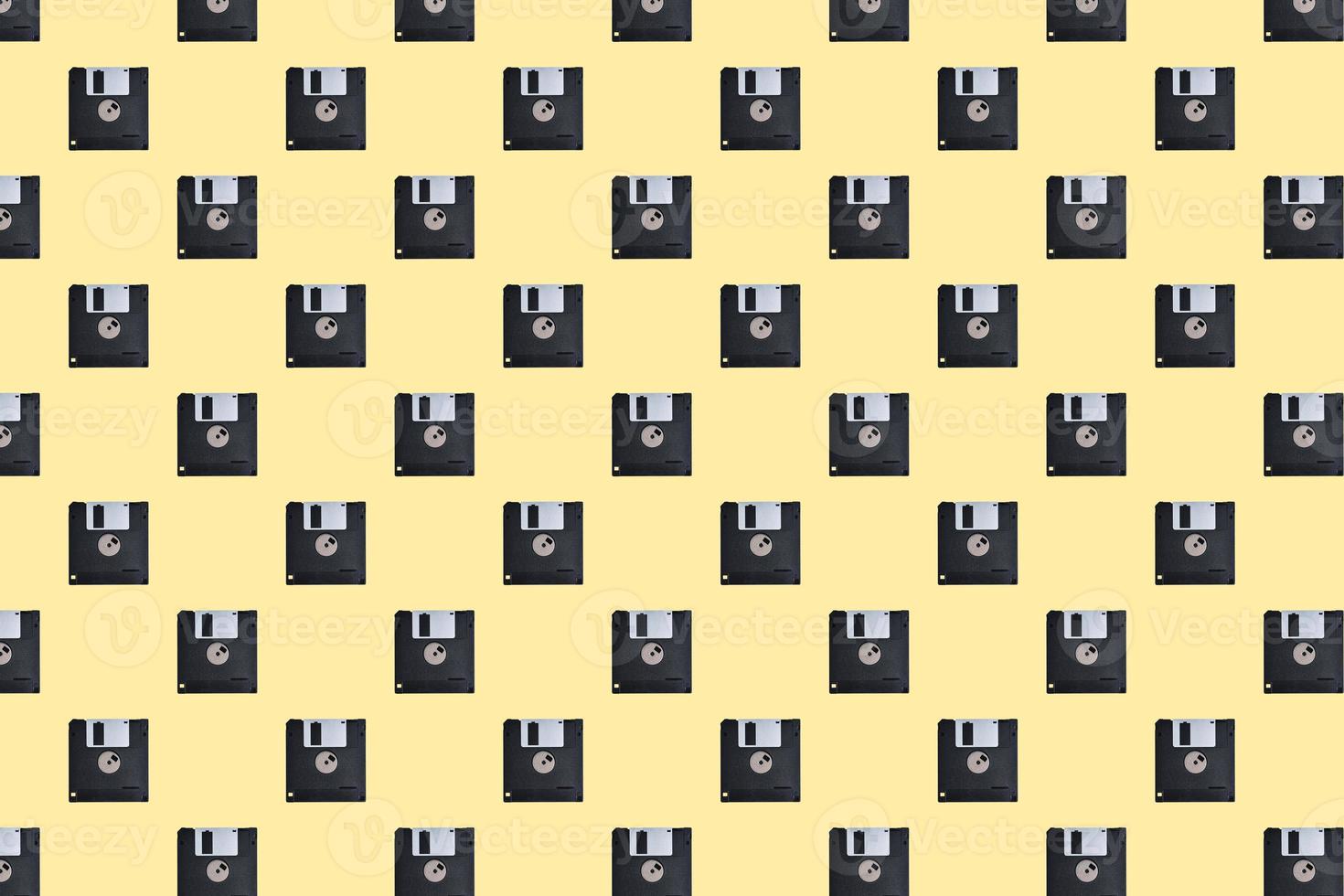 Floppy diskette pattern on yellow background photo