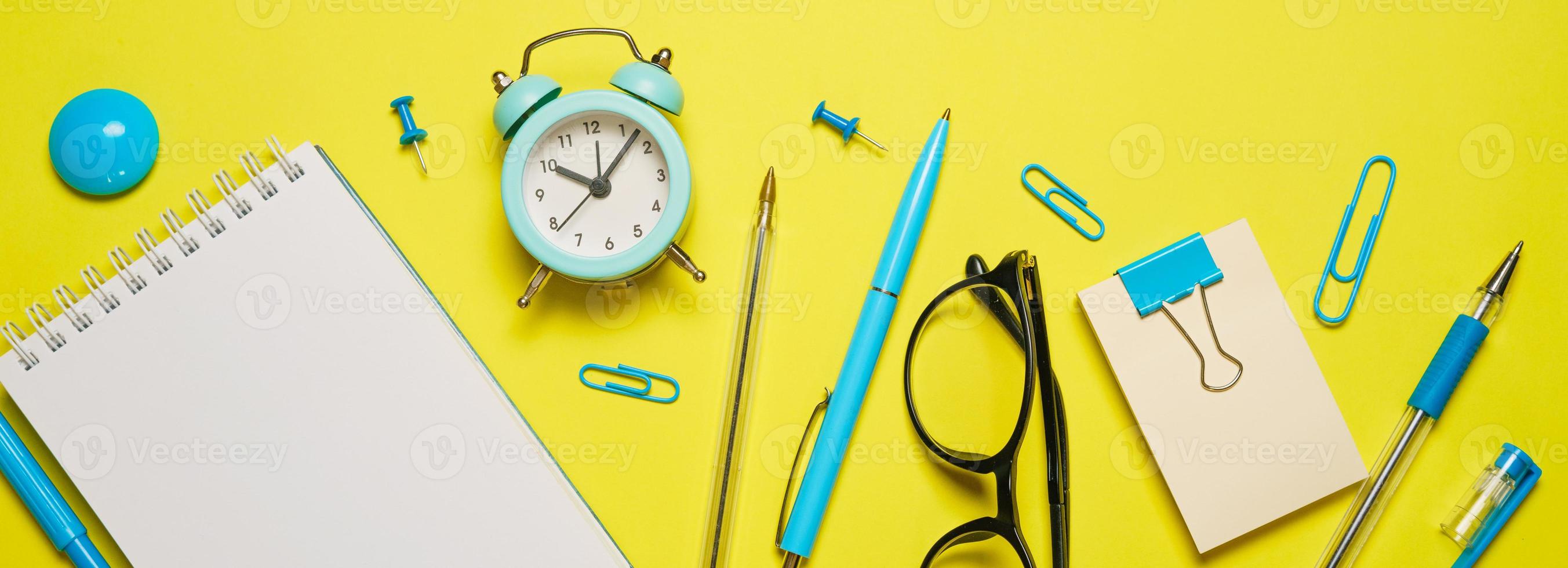 Notebook on a spring for notes and stationery lie on a yellow background Office photo
