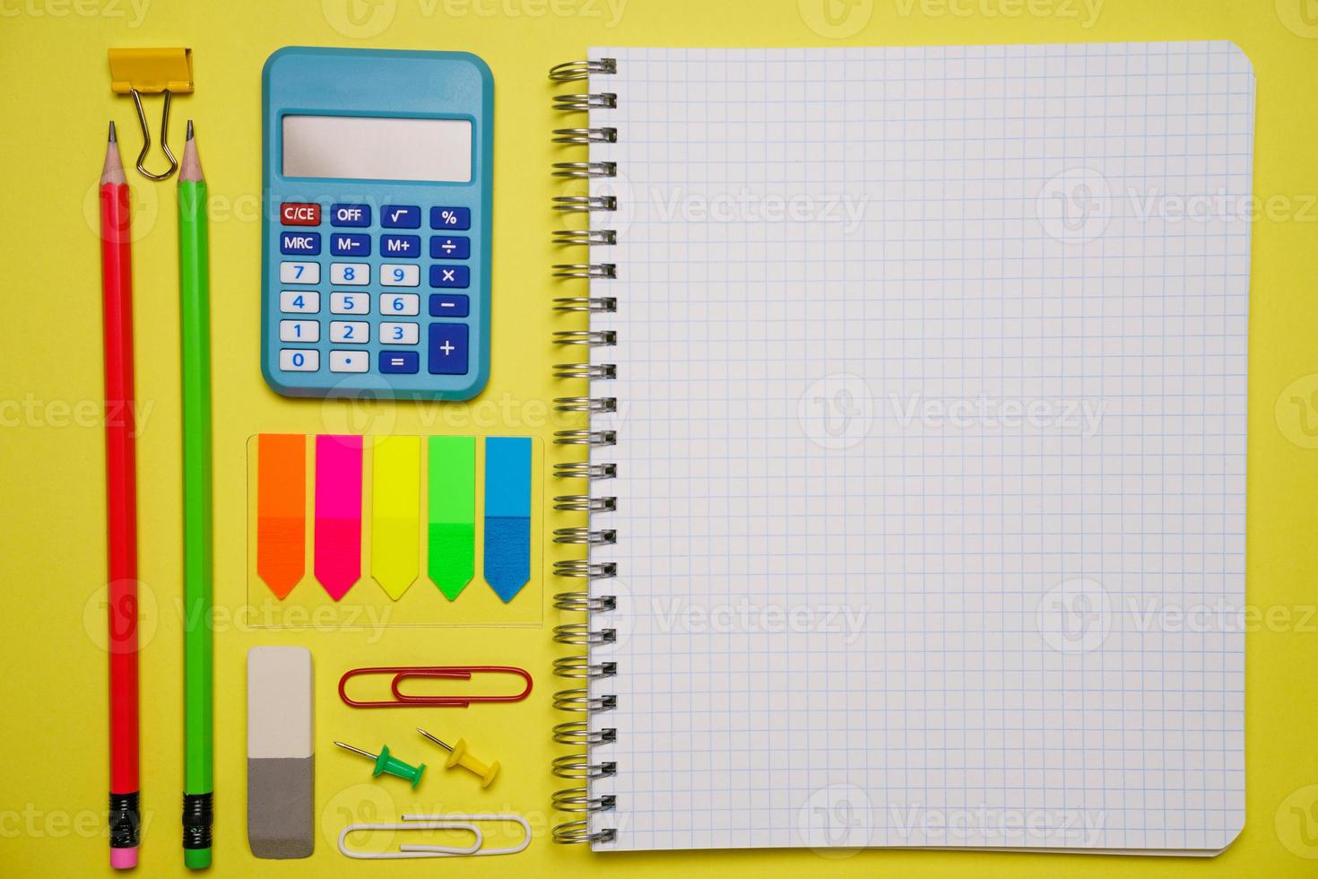 Notebook with a pen and colorful notes on a blue and orange background. photo