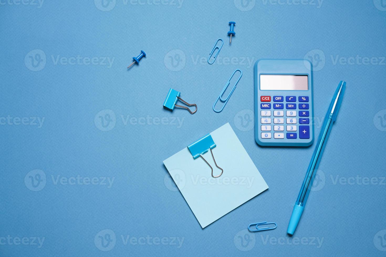 School objects, office supplies, tools and accessories isolated on blue photo