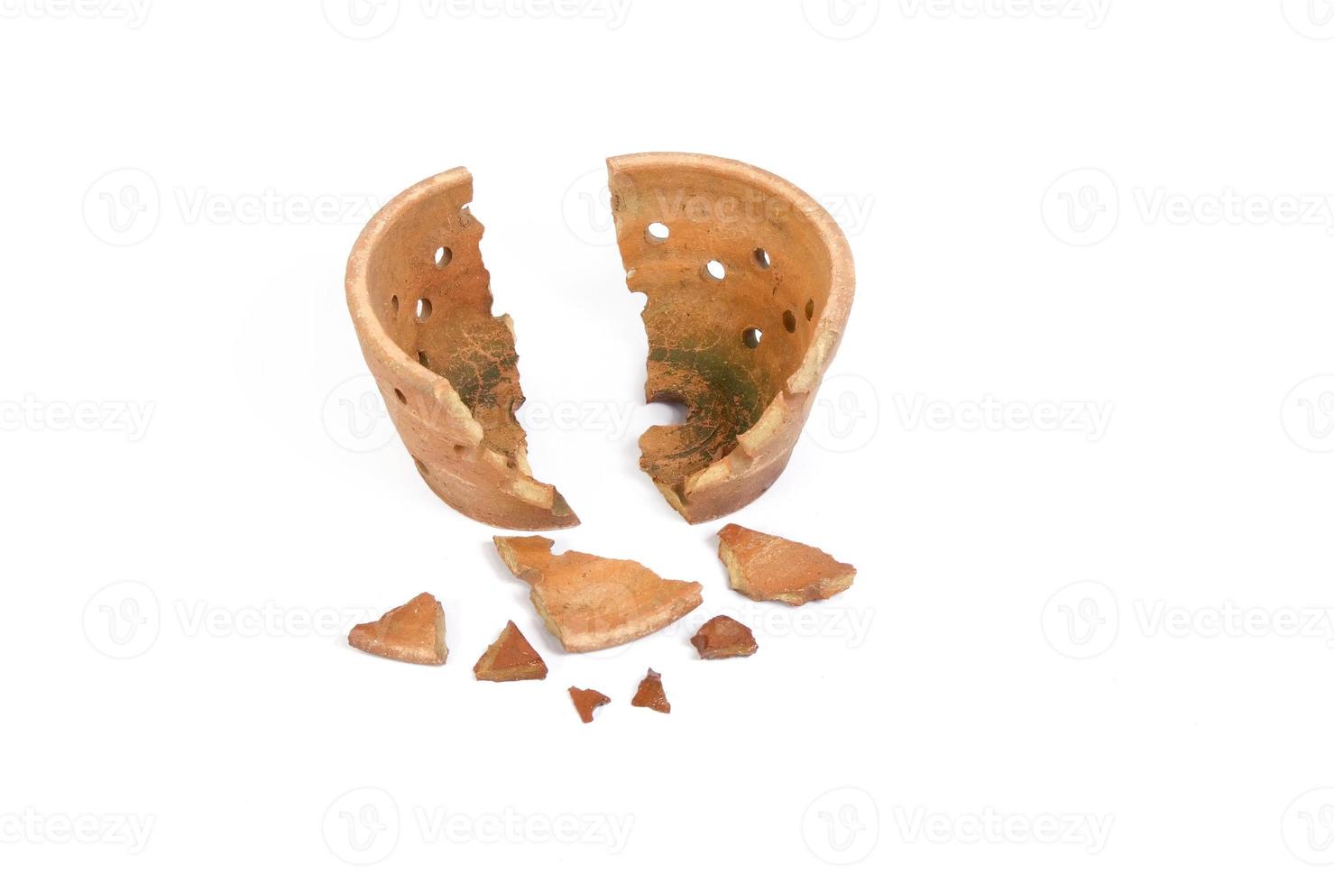 Broken antique clay pot on a white background photo