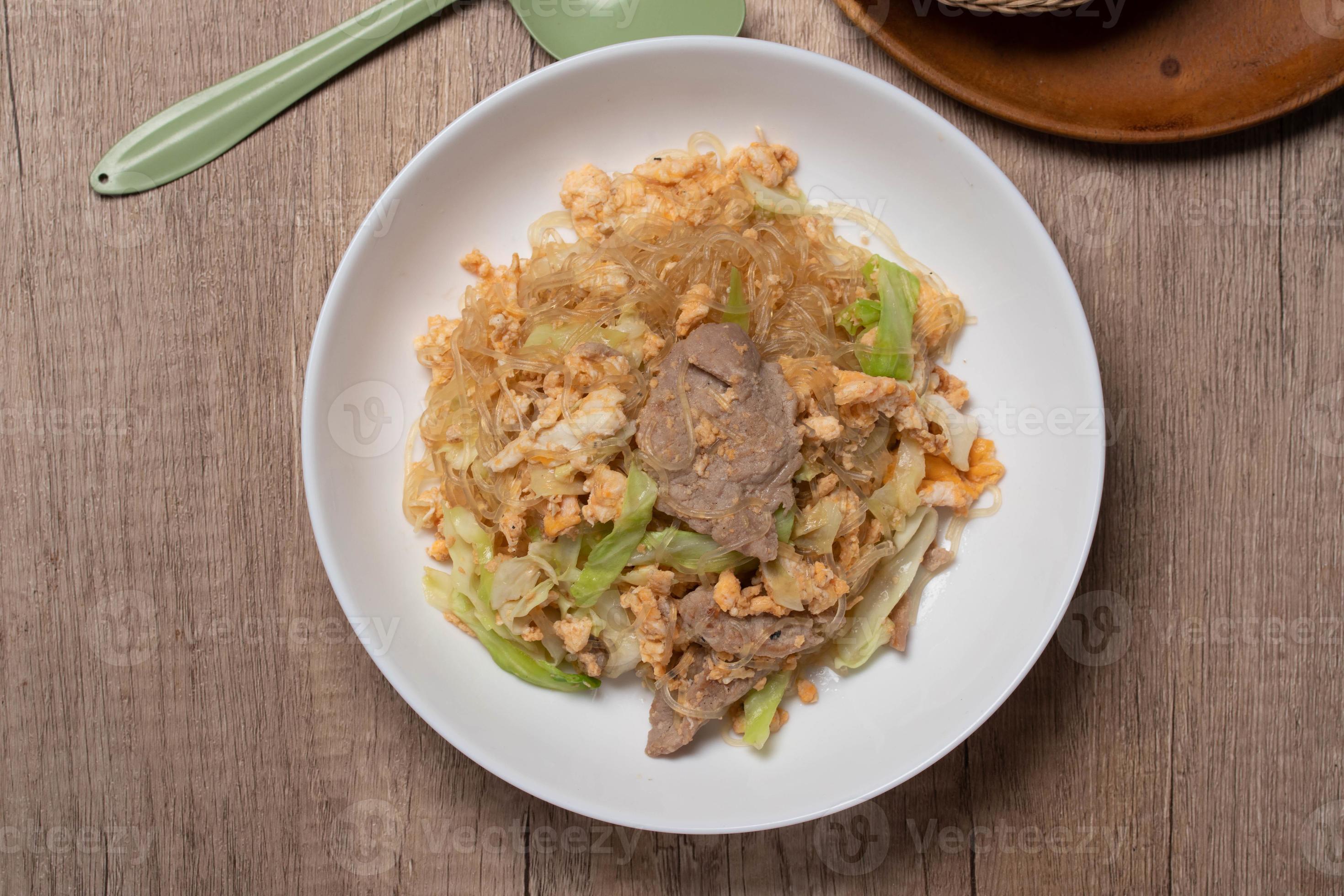 Stir fried vermicelli with pork, egg and collard greens in a white