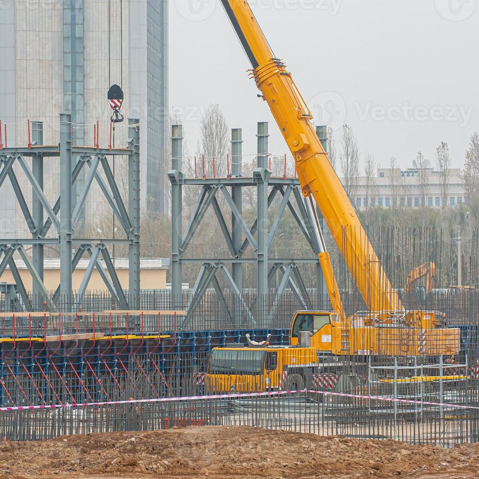 A track crane working in a industrial construction area photo