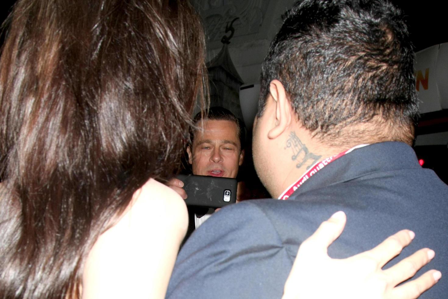 LOS ANGELES - NOV 5 - Brad Pitt, taking a picture of Angelina Jolie Pitt and fan at the AFI FEST 2015 Presented By Audi Opening Night Gala Premiere of By The Sea at the TCL Chinese Theater on November 5, 2015 in Los Angeles, CA photo