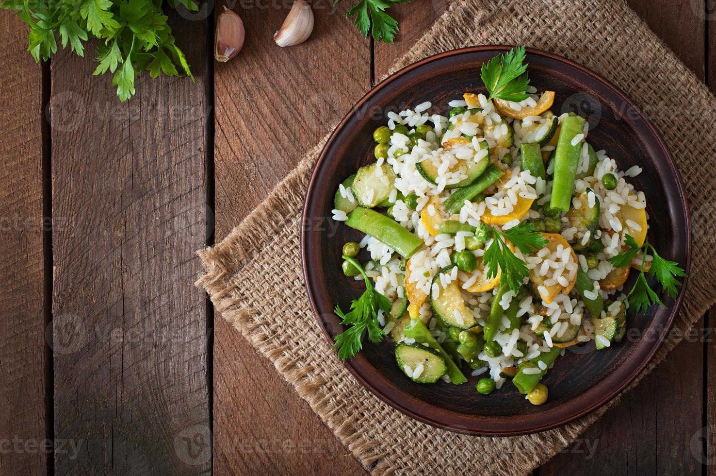 Risotto with asparagus beans, zucchini and green peas photo