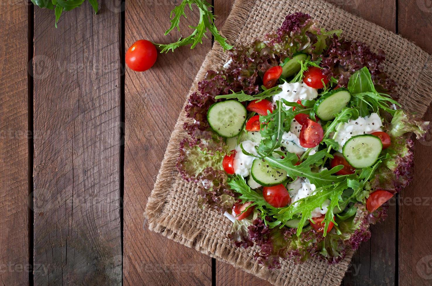 Useful dietary salad with cottage cheese, herbs and vegetables photo
