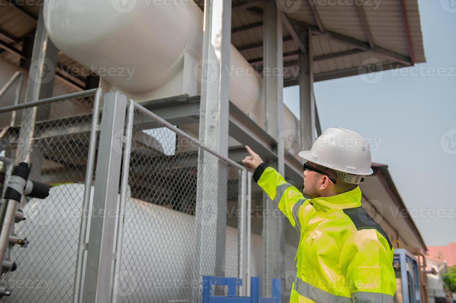 Engineers work place to keep liquid helium,preventive maintenance schedule checking,Thailand people,Technicians and engineers discuss work together. photo