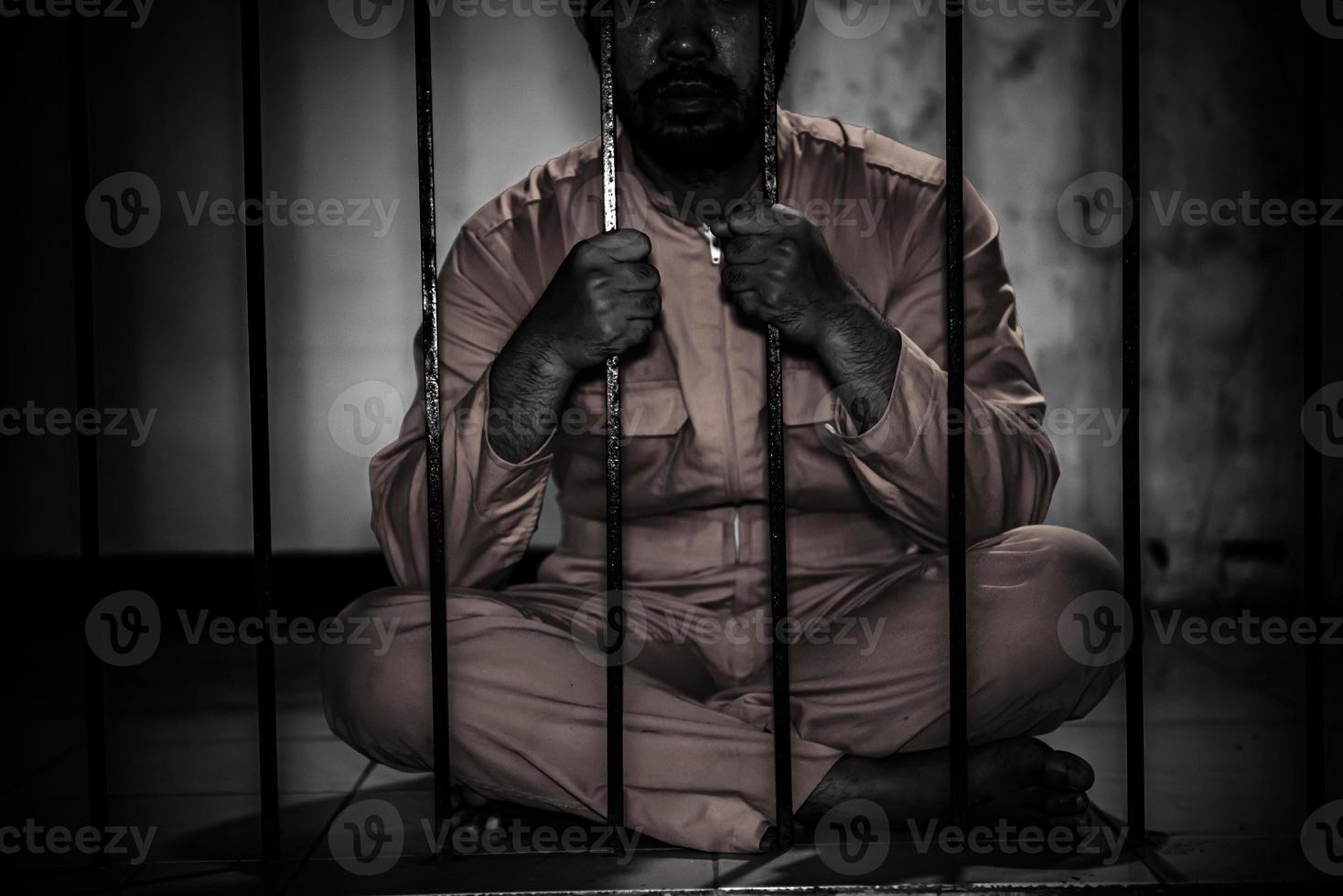 Portrait of man desperate to catch the iron prison,prisoner concept,thailand people,Hope to be free,If the violate the law would be arrested and jailed. photo