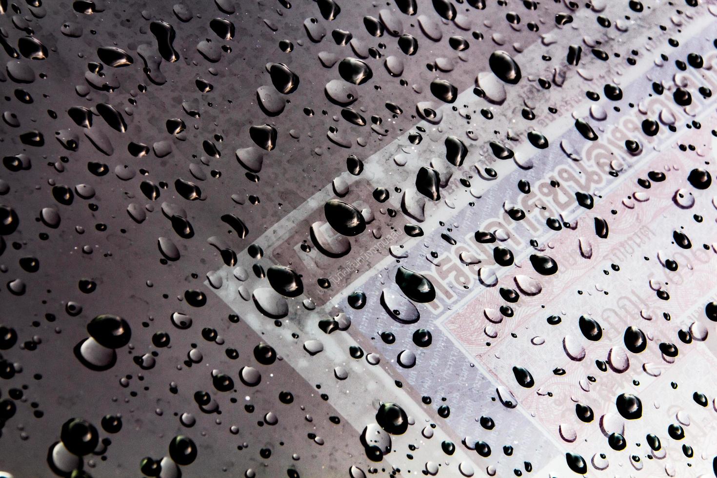 Drops of water and water beads on clear glass. photo