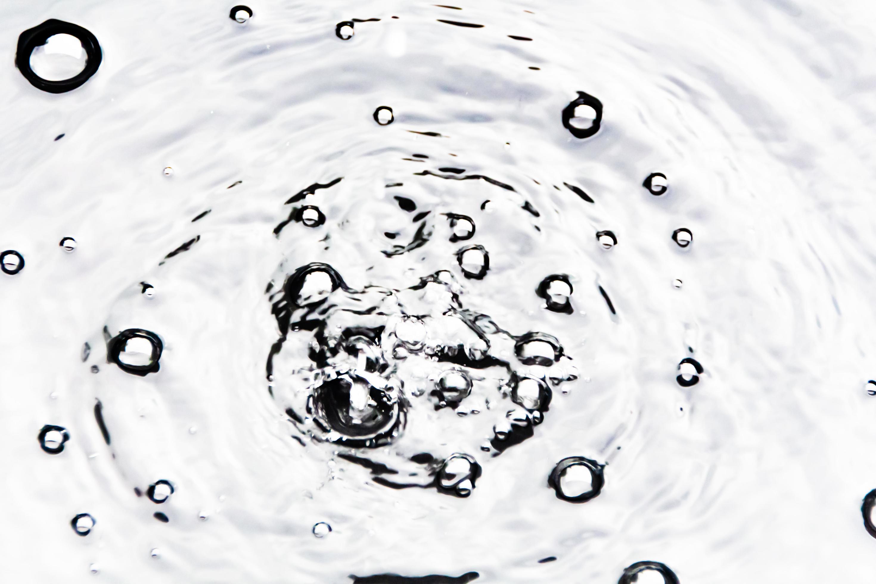 Water droplets or water beads fall on the water surface causing the
